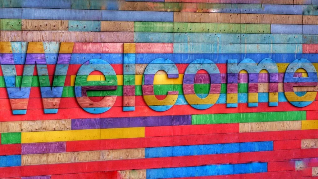 A multi-colored wooden sign reading "Welcome"